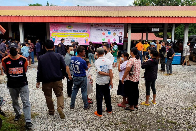 In this image taken from video, officials enter the site of an attack at a daycare canter, Thursday, Oct. 6, 2022, in the town of Nongbua Lamphu, north eastern Thailand. More than 30 people, primarily children, were killed Thursday when a gunman opened fire the childcare center authorities said. (TPBS via AP)