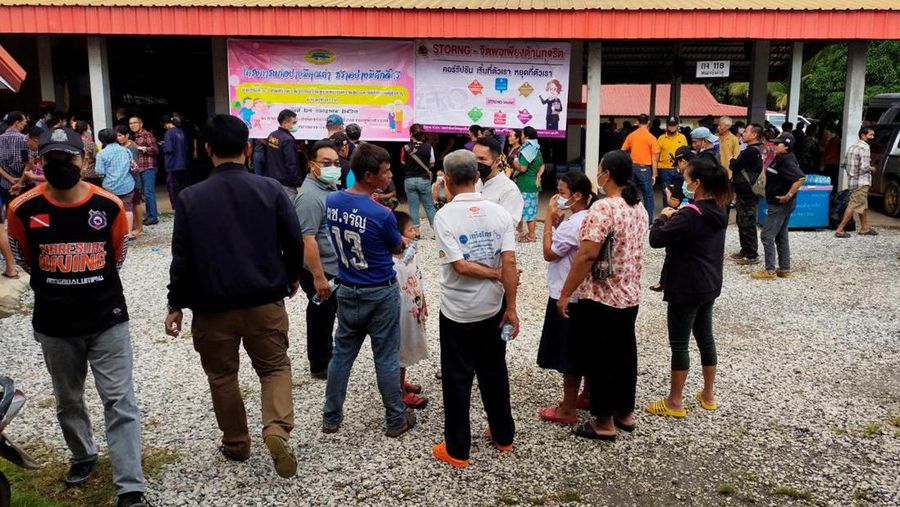 In this image taken from video, officials enter the site of an attack at a daycare canter, Thursday, Oct. 6, 2022, in the town of Nongbua Lamphu, north eastern Thailand. More than 30 people, primarily children, were killed Thursday when a gunman opened fire the childcare center authorities said. (TPBS via AP)