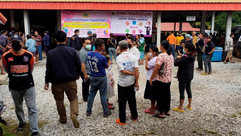 In this image taken from video, officials enter the site of an attack at a daycare canter, Thursday, Oct. 6, 2022, in the town of Nongbua Lamphu, north eastern Thailand. More than 30 people, primarily children, were killed Thursday when a gunman opened fire the childcare center authorities said. (TPBS via AP)