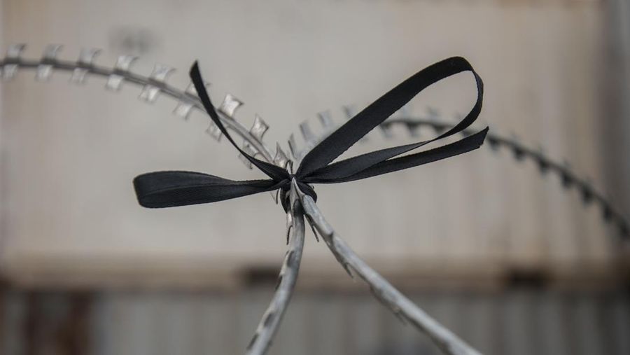 BANGKOK, THAILAND - 2021/03/13: Black ribbon seen tied on the barbed wire fence during the demonstration.
The pro-democracy protesters gather at the Democracy Monument before marching to the Government house of Thailand to demand the reform of the monarchy and abolish the lese majesty law (article 112 of the Thai criminal code) and reassignment of Thailand's Prime Minister Prayut Chan-o-cha. (Photo by Peerapon Boonyakiat/SOPA Images/LightRocket via Getty Images)