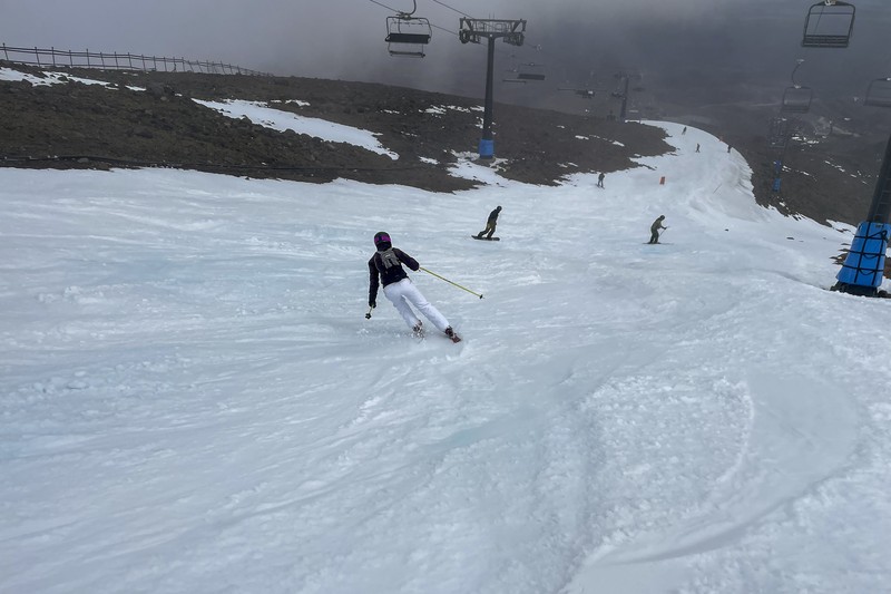 New Zealand Ski Troubles Skiers make the most of the very little snow at the Tūroa ski field, on Mt Ruapehu, New Zealand on Sept. 22, 2022. A disastrous snow season has left two of New Zealand's largest ski fields on the brink of bankruptcy, with climate change appearing to play a significant role. (AP Photo/Nick Perry)