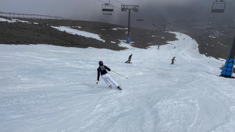 Skiers make the most of the very little snow at the Tūroa ski field, on Mt Ruapehu, New Zealand on Sept. 22, 2022. A disastrous snow season has left two of New Zealand's largest ski fields on the brink of bankruptcy, with climate change appearing to play a significant role. (AP Photo/Nick Perry)