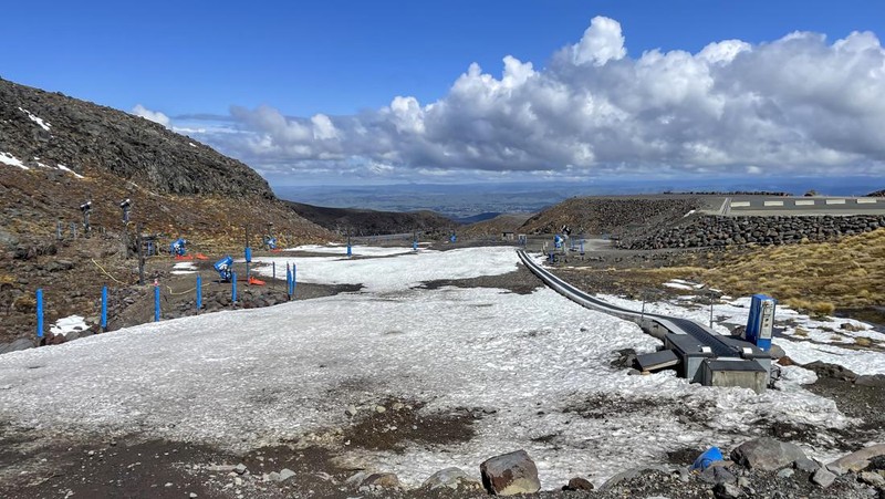 Skiers make the most of the very little snow at the Tūroa ski field, on Mt Ruapehu, New Zealand on Sept. 22, 2022. A disastrous snow season has left two of New Zealand's largest ski fields on the brink of bankruptcy, with climate change appearing to play a significant role. (AP Photo/Nick Perry)