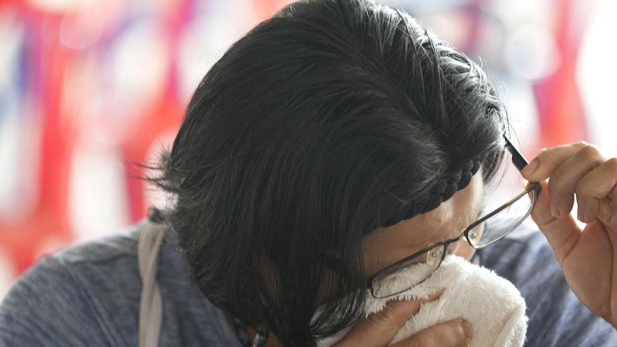 A relative of a victim cries outside the Childcenter Uthai Sawan that was attacked by a lone assailant in the rural town of Uthai Sawan, north eastern Thailand, early Friday, Oct. 7, 2022. A former policeman facing a drug charge burst into a day care center in northeastern Thailand on Thursday, killing dozens of preschoolers and teachers before shooting more people as he fled in the deadliest rampage in the nation's history. (AP Photo/Sakchai Lalit)