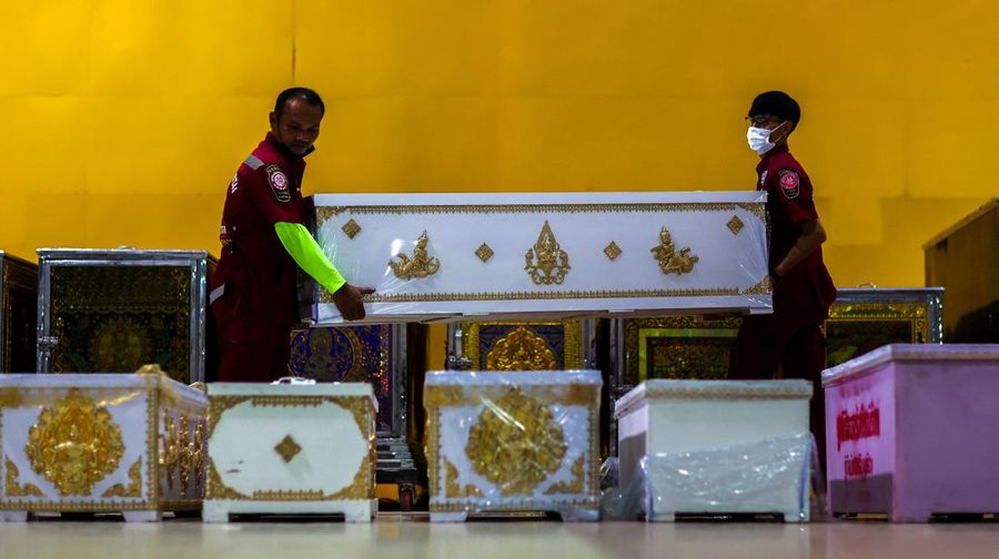 Rescue workers arrange coffins containing the body of victims at Song Serm Tham Foundation after transfer from Udon Thani hospital in Udon Thani province, following a mass shooting in the town of Uthai Sawan, around 500 km northeast of Bangkok in the province of Nong Bua Lam Phu, Thailand October 7, 2022. REUTERS/Athit Perawongmetha