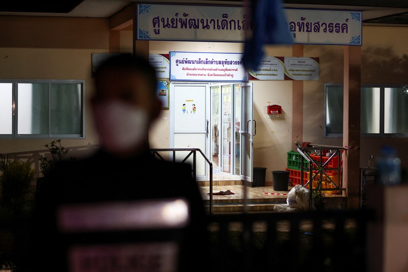 A police officer stands outside a day care center which was the scene of a mass shooting, in the town of Uthai Sawan, around 500 km northeast of Bangkok in the province of Nong Bua Lam Phu, Thailand October 6, 2022. REUTERS/Athit Perawongmetha