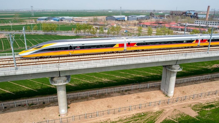 1239829905 ANYANG, CHINA - APRIL 6, 2022 - Aerial photo show a high-speed railway comprehensive inspection train, which will be exported to Indonesia, passes by on the Jinan-Zhengzhou High-speed Railway in Anyang, Henan Province, China, April 6, 2022. This is the first run of this type of train in China. The Jakarta-Bandung high-speed Railway (JAKarta-Bandung High-Speed Railway) is a high-speed Railway connecting the Greater Jakarta metropolitan area of the Republic of Indonesia with West Java province. It is the first high-speed Railway in Southeast Asia and will be operational in June 2023. The high-speed railway comprehensive inspection train, as an essential and important technical equipment to ensure the safety of high-speed railway line operation, also travels at 350 kilometers per hour. It is used to detect train track condition, measure current and overhead power, test or check communication and signal network and even wheel to track dynamics, etc. It will play a key role in the joint commissioning and trial of jakarta-Bandung high-speed railway and infrastructure maintenance. The Jakarta-Bandung high-speed Railway is a link between China's Belt and Road Initiative and Indonesia's Ocean Fulcrum Strategy. It is a landmark project of practical cooperation between China and Indonesia and also a national strategic project of Indonesia. It connects the capital Jakarta and the fourth largest city Bandung with a length of 142 kilometers and a maximum design speed of 350 kilometers. When completed, the travel time between Jakarta and Bandung will be reduced from more than three hours to 40 minutes. (Photo credit should read Costfoto/Future Publishing via Getty Images)