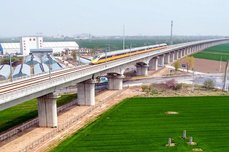 ANYANG, CHINA - APRIL 6, 2022 - Aerial photo show a high-speed railway comprehensive inspection train, which will be exported to Indonesia, passes by on the Jinan-Zhengzhou High-speed Railway in Anyang, Henan Province, China, April 6, 2022. This is the first run of this type of train in China. The Jakarta-Bandung high-speed Railway (JAKarta-Bandung High-Speed Railway) is a high-speed Railway connecting the Greater Jakarta metropolitan area of the Republic of Indonesia with West Java province. It is the first high-speed Railway in Southeast Asia and will be operational in June 2023. The high-speed railway comprehensive inspection train, as an essential and important technical equipment to ensure the safety of high-speed railway line operation, also travels at 350 kilometers per hour. It is used to detect train track condition, measure current and overhead power, test or check communication and signal network and even wheel to track dynamics, etc. It will play a key role in the joint commissioning and trial of jakarta-Bandung high-speed railway and infrastructure maintenance. The Jakarta-Bandung high-speed Railway is a link between China's Belt and Road Initiative and Indonesia's Ocean Fulcrum Strategy. It is a landmark project of practical cooperation between China and Indonesia and also a national strategic project of Indonesia. It connects the capital Jakarta and the fourth largest city Bandung with a length of 142 kilometers and a maximum design speed of 350 kilometers. When completed, the travel time between Jakarta and Bandung will be reduced from more than three hours to 40 minutes. (Photo credit should read Costfoto/Future Publishing via Getty Images)