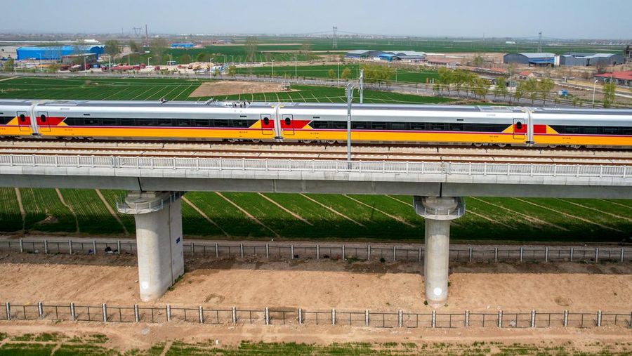ANYANG, CHINA - APRIL 6, 2022 - Aerial photo show a high-speed railway comprehensive inspection train, which will be exported to Indonesia, passes by on the Jinan-Zhengzhou High-speed Railway in Anyang, Henan Province, China, April 6, 2022. This is the first run of this type of train in China. The Jakarta-Bandung high-speed Railway (JAKarta-Bandung High-Speed Railway) is a high-speed Railway connecting the Greater Jakarta metropolitan area of the Republic of Indonesia with West Java province. It is the first high-speed Railway in Southeast Asia and will be operational in June 2023. The high-speed railway comprehensive inspection train, as an essential and important technical equipment to ensure the safety of high-speed railway line operation, also travels at 350 kilometers per hour. It is used to detect train track condition, measure current and overhead power, test or check communication and signal network and even wheel to track dynamics, etc. It will play a key role in the joint commissioning and trial of jakarta-Bandung high-speed railway and infrastructure maintenance. The Jakarta-Bandung high-speed Railway is a link between China's Belt and Road Initiative and Indonesia's Ocean Fulcrum Strategy. It is a landmark project of practical cooperation between China and Indonesia and also a national strategic project of Indonesia. It connects the capital Jakarta and the fourth largest city Bandung with a length of 142 kilometers and a maximum design speed of 350 kilometers. When completed, the travel time between Jakarta and Bandung will be reduced from more than three hours to 40 minutes. (Photo credit should read Costfoto/Future Publishing via Getty Images)