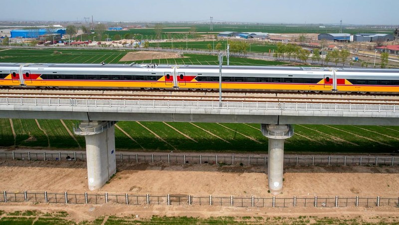 ANYANG, CHINA - APRIL 6, 2022 - Aerial photo show a high-speed railway comprehensive inspection train, which will be exported to Indonesia, passes by on the Jinan-Zhengzhou High-speed Railway in Anyang, Henan Province, China, April 6, 2022. This is the first run of this type of train in China. The Jakarta-Bandung high-speed Railway (JAKarta-Bandung High-Speed Railway) is a high-speed Railway connecting the Greater Jakarta metropolitan area of the Republic of Indonesia with West Java province. It is the first high-speed Railway in Southeast Asia and will be operational in June 2023. The high-speed railway comprehensive inspection train, as an essential and important technical equipment to ensure the safety of high-speed railway line operation, also travels at 350 kilometers per hour. It is used to detect train track condition, measure current and overhead power, test or check communication and signal network and even wheel to track dynamics, etc. It will play a key role in the joint commissioning and trial of jakarta-Bandung high-speed railway and infrastructure maintenance. The Jakarta-Bandung high-speed Railway is a link between China's Belt and Road Initiative and Indonesia's Ocean Fulcrum Strategy. It is a landmark project of practical cooperation between China and Indonesia and also a national strategic project of Indonesia. It connects the capital Jakarta and the fourth largest city Bandung with a length of 142 kilometers and a maximum design speed of 350 kilometers. When completed, the travel time between Jakarta and Bandung will be reduced from more than three hours to 40 minutes. (Photo credit should read Costfoto/Future Publishing via Getty Images)