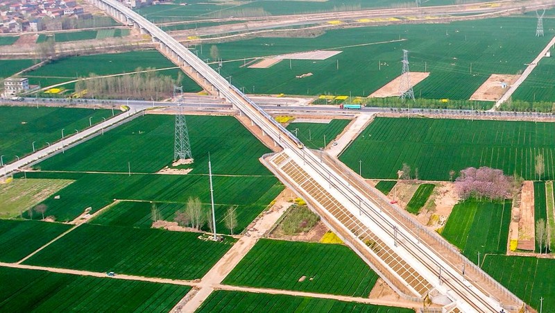 ANYANG, CHINA - APRIL 6, 2022 - Aerial photo show a high-speed railway comprehensive inspection train, which will be exported to Indonesia, passes by on the Jinan-Zhengzhou High-speed Railway in Anyang, Henan Province, China, April 6, 2022. This is the first run of this type of train in China. The Jakarta-Bandung high-speed Railway (JAKarta-Bandung High-Speed Railway) is a high-speed Railway connecting the Greater Jakarta metropolitan area of the Republic of Indonesia with West Java province. It is the first high-speed Railway in Southeast Asia and will be operational in June 2023. The high-speed railway comprehensive inspection train, as an essential and important technical equipment to ensure the safety of high-speed railway line operation, also travels at 350 kilometers per hour. It is used to detect train track condition, measure current and overhead power, test or check communication and signal network and even wheel to track dynamics, etc. It will play a key role in the joint commissioning and trial of jakarta-Bandung high-speed railway and infrastructure maintenance. The Jakarta-Bandung high-speed Railway is a link between China's Belt and Road Initiative and Indonesia's Ocean Fulcrum Strategy. It is a landmark project of practical cooperation between China and Indonesia and also a national strategic project of Indonesia. It connects the capital Jakarta and the fourth largest city Bandung with a length of 142 kilometers and a maximum design speed of 350 kilometers. When completed, the travel time between Jakarta and Bandung will be reduced from more than three hours to 40 minutes. (Photo credit should read Costfoto/Future Publishing via Getty Images)