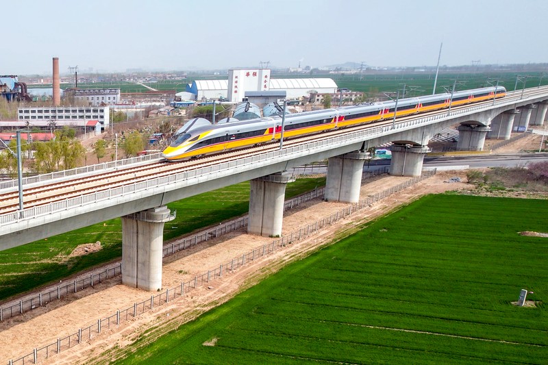 ANYANG, CHINA - APRIL 6, 2022 - Aerial photo show a high-speed railway comprehensive inspection train, which will be exported to Indonesia, passes by on the Jinan-Zhengzhou High-speed Railway in Anyang, Henan Province, China, April 6, 2022. This is the first run of this type of train in China. The Jakarta-Bandung high-speed Railway (JAKarta-Bandung High-Speed Railway) is a high-speed Railway connecting the Greater Jakarta metropolitan area of the Republic of Indonesia with West Java province. It is the first high-speed Railway in Southeast Asia and will be operational in June 2023. The high-speed railway comprehensive inspection train, as an essential and important technical equipment to ensure the safety of high-speed railway line operation, also travels at 350 kilometers per hour. It is used to detect train track condition, measure current and overhead power, test or check communication and signal network and even wheel to track dynamics, etc. It will play a key role in the joint commissioning and trial of jakarta-Bandung high-speed railway and infrastructure maintenance. The Jakarta-Bandung high-speed Railway is a link between China's Belt and Road Initiative and Indonesia's Ocean Fulcrum Strategy. It is a landmark project of practical cooperation between China and Indonesia and also a national strategic project of Indonesia. It connects the capital Jakarta and the fourth largest city Bandung with a length of 142 kilometers and a maximum design speed of 350 kilometers. When completed, the travel time between Jakarta and Bandung will be reduced from more than three hours to 40 minutes. (Photo credit should read Costfoto/Future Publishing via Getty Images)