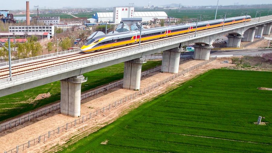 ANYANG, CHINA - APRIL 6, 2022 - Aerial photo show a high-speed railway comprehensive inspection train, which will be exported to Indonesia, passes by on the Jinan-Zhengzhou High-speed Railway in Anyang, Henan Province, China, April 6, 2022. This is the first run of this type of train in China. The Jakarta-Bandung high-speed Railway (JAKarta-Bandung High-Speed Railway) is a high-speed Railway connecting the Greater Jakarta metropolitan area of the Republic of Indonesia with West Java province. It is the first high-speed Railway in Southeast Asia and will be operational in June 2023. The high-speed railway comprehensive inspection train, as an essential and important technical equipment to ensure the safety of high-speed railway line operation, also travels at 350 kilometers per hour. It is used to detect train track condition, measure current and overhead power, test or check communication and signal network and even wheel to track dynamics, etc. It will play a key role in the joint commissioning and trial of jakarta-Bandung high-speed railway and infrastructure maintenance. The Jakarta-Bandung high-speed Railway is a link between China's Belt and Road Initiative and Indonesia's Ocean Fulcrum Strategy. It is a landmark project of practical cooperation between China and Indonesia and also a national strategic project of Indonesia. It connects the capital Jakarta and the fourth largest city Bandung with a length of 142 kilometers and a maximum design speed of 350 kilometers. When completed, the travel time between Jakarta and Bandung will be reduced from more than three hours to 40 minutes. (Photo credit should read Costfoto/Future Publishing via Getty Images)