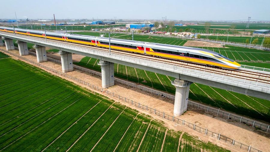 ANYANG, CHINA - APRIL 6, 2022 - Aerial photo show a high-speed railway comprehensive inspection train, which will be exported to Indonesia, passes by on the Jinan-Zhengzhou High-speed Railway in Anyang, Henan Province, China, April 6, 2022. This is the first run of this type of train in China. The Jakarta-Bandung high-speed Railway (JAKarta-Bandung High-Speed Railway) is a high-speed Railway connecting the Greater Jakarta metropolitan area of the Republic of Indonesia with West Java province. It is the first high-speed Railway in Southeast Asia and will be operational in June 2023. The high-speed railway comprehensive inspection train, as an essential and important technical equipment to ensure the safety of high-speed railway line operation, also travels at 350 kilometers per hour. It is used to detect train track condition, measure current and overhead power, test or check communication and signal network and even wheel to track dynamics, etc. It will play a key role in the joint commissioning and trial of jakarta-Bandung high-speed railway and infrastructure maintenance. The Jakarta-Bandung high-speed Railway is a link between China's Belt and Road Initiative and Indonesia's Ocean Fulcrum Strategy. It is a landmark project of practical cooperation between China and Indonesia and also a national strategic project of Indonesia. It connects the capital Jakarta and the fourth largest city Bandung with a length of 142 kilometers and a maximum design speed of 350 kilometers. When completed, the travel time between Jakarta and Bandung will be reduced from more than three hours to 40 minutes. (Photo credit should read Costfoto/Future Publishing via Getty Images)
