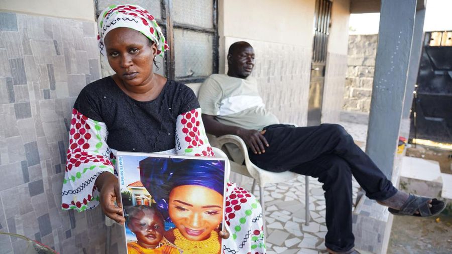 Mariama Kuyateh, 30, holds up a picture of her late son Musawho died from acute kidney failure, in Banjul on October 10, 2022, - Gambian police on October 8, 2022,  announced an investigation into four cough syrups made by the Indian Pharma company Maiden Pharmaceuticals, after the WHO said they could be responsible for the deaths of 66 Gambian children, most under 5-years-old. Nearly half of The Gambia's population lives below the poverty line, according to the World Bank. (Photo by MILAN BERCKMANS / AFP) (Photo by MILAN BERCKMANS/AFP via Getty Images)