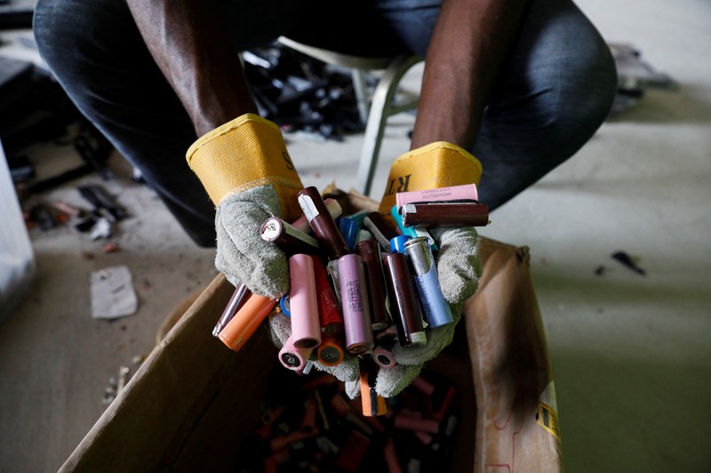 NIGERIA-SOLAR/WASTE An employee holds a handful of lithium-ion cells from old laptop battery packs at the Quadloop recycling facility in Lagos, Nigeria October 4, 2022. REUTERS/Temilade Adelaja