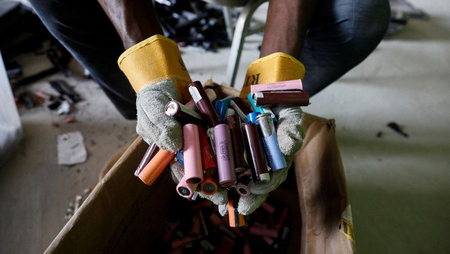 An employee holds a handful of lithium-ion cells from old laptop battery packs at the Quadloop recycling facility in Lagos, Nigeria October 4, 2022. REUTERS/Temilade Adelaja