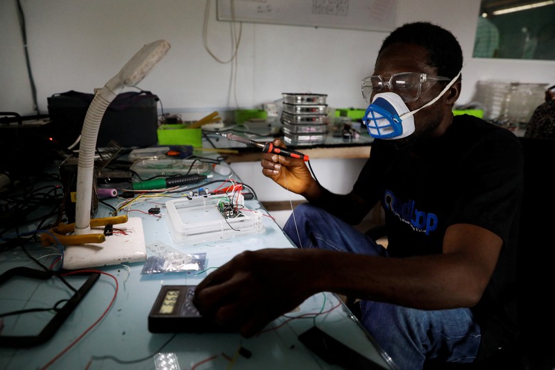 NIGERIA-SOLAR/WASTE An employee holds a handful of lithium-ion cells from old laptop battery packs at the Quadloop recycling facility in Lagos, Nigeria October 4, 2022. REUTERS/Temilade Adelaja