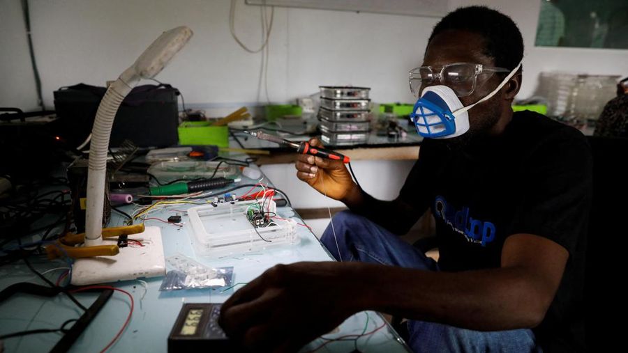 An employee holds a handful of lithium-ion cells from old laptop battery packs at the Quadloop recycling facility in Lagos, Nigeria October 4, 2022. REUTERS/Temilade Adelaja