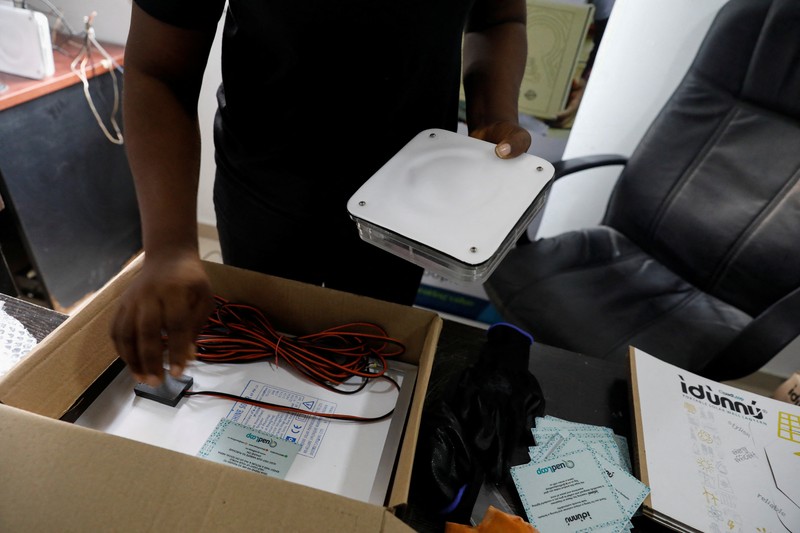 NIGERIA-SOLAR/WASTE An employee holds a handful of lithium-ion cells from old laptop battery packs at the Quadloop recycling facility in Lagos, Nigeria October 4, 2022. REUTERS/Temilade Adelaja