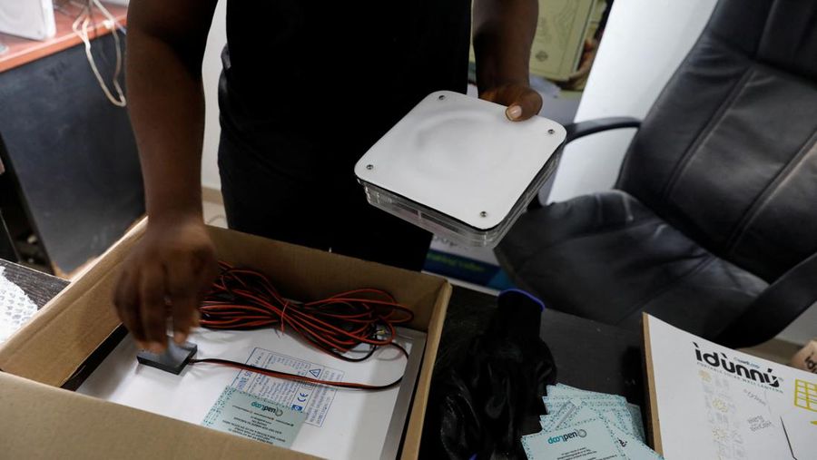 An employee holds a handful of lithium-ion cells from old laptop battery packs at the Quadloop recycling facility in Lagos, Nigeria October 4, 2022. REUTERS/Temilade Adelaja