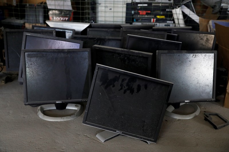 NIGERIA-SOLAR/WASTE An employee holds a handful of lithium-ion cells from old laptop battery packs at the Quadloop recycling facility in Lagos, Nigeria October 4, 2022. REUTERS/Temilade Adelaja