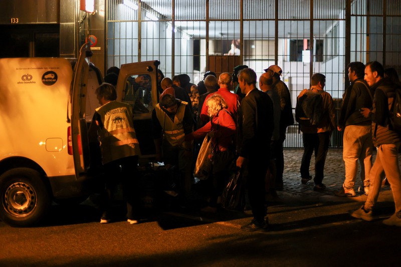 People wait in line to collect food from homeless charity CASA in central Lisbon, Portugal October 11, 2022. REUTERS/Pedro Nunes