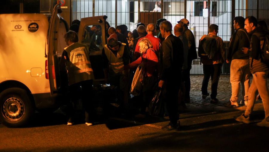 People wait in line to collect food from homeless charity CASA in central Lisbon, Portugal October 11, 2022. REUTERS/Pedro Nunes