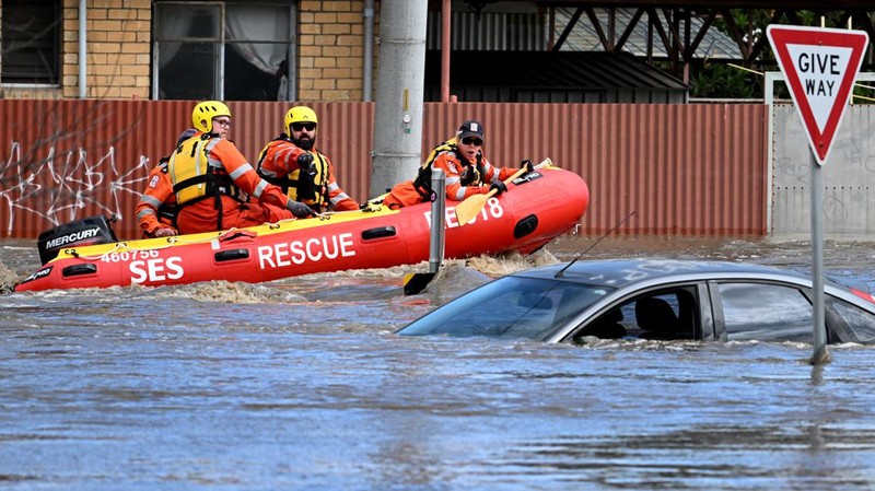 Pekerja darurat mengevakuasi warga saat banjir di pinggiran Melbourne, Maribyrnong, Australia, Jumat (14102/2022). Banjir telah menggenangi jalan, memaksa sekolah ditutup, dan memutus aliran listrik ke 3.000 rumah dan bisnis. (Photo by WILLIAM WEST/AFP via Getty Images)