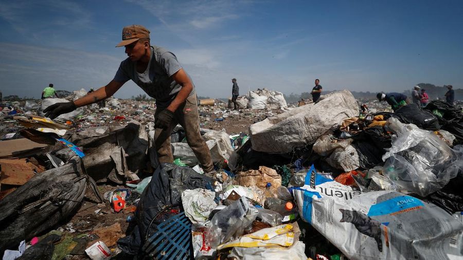Waste recyclers look through heaps of waste at a landfill for cardboard, plastic and metal, which they sell while working 12-hour shifts, as Argentina faces one of the world's highest inflation rates, set to top 100% this year, in Lujan, on the outskirts of Buenos Aires, Argentina October 5, 2022. REUTERS/Agustin Marcarian