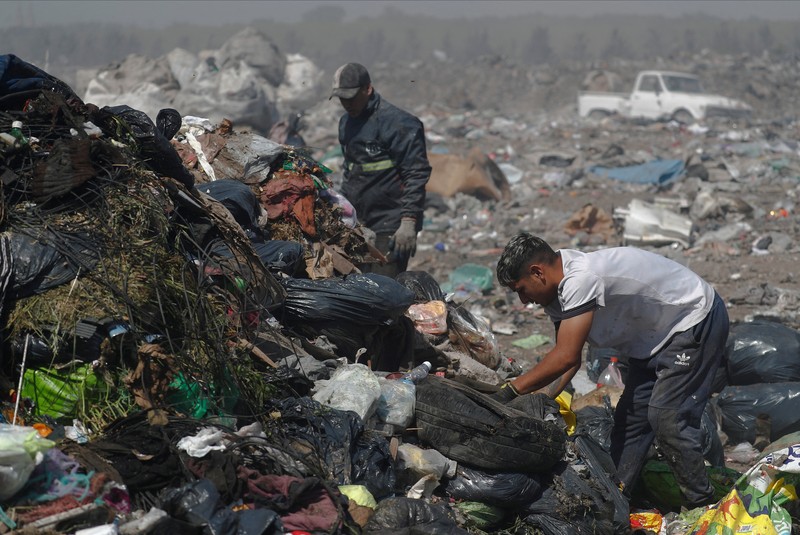 Waste recyclers look through heaps of waste at a landfill for cardboard, plastic and metal, which they sell while working 12-hour shifts, as Argentina faces one of the world's highest inflation rates, set to top 100% this year, in Lujan, on the outskirts of Buenos Aires, Argentina October 5, 2022. REUTERS/Agustin Marcarian