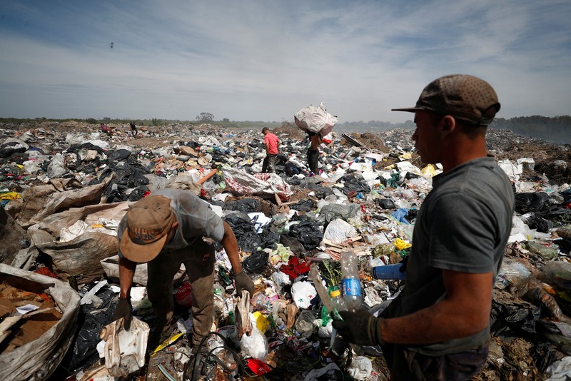 ARGENTINA-INFLATION/POVERTY Waste recyclers look through heaps of waste at a landfill for cardboard, plastic and metal, which they sell while working 12-hour shifts, as Argentina faces one of the world's highest inflation rates, set to top 100% this year, in Lujan, on the outskirts of Buenos Aires, Argentina October 5, 2022. REUTERS/Agustin Marcarian