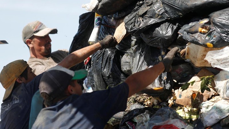 Waste recyclers look through heaps of waste at a landfill for cardboard, plastic and metal, which they sell while working 12-hour shifts, as Argentina faces one of the world's highest inflation rates, set to top 100% this year, in Lujan, on the outskirts of Buenos Aires, Argentina October 5, 2022. REUTERS/Agustin Marcarian