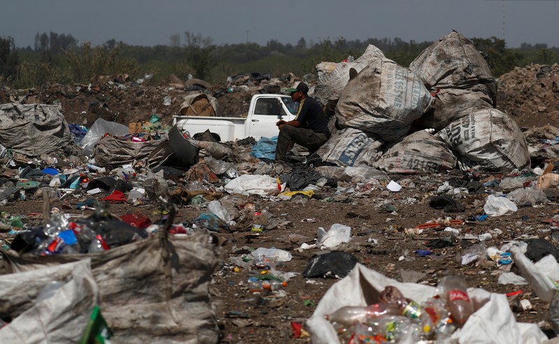 Waste recyclers look through heaps of waste at a landfill for cardboard, plastic and metal, which they sell while working 12-hour shifts, as Argentina faces one of the world's highest inflation rates, set to top 100% this year, in Lujan, on the outskirts of Buenos Aires, Argentina October 5, 2022. REUTERS/Agustin Marcarian