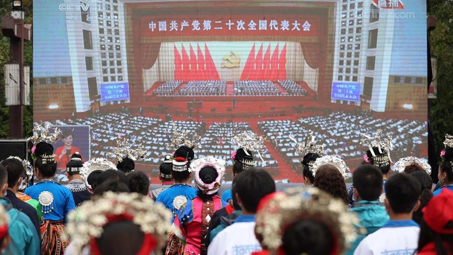 Ethnic minority members watch the opening session of the 20th Chinese Communist Party Congress on a screen in Danzhai, in Chinas southwestern Guizhou province on October 16, 2022. - China OUT (Photo by AFP) / China OUT (Photo by STR/AFP via Getty Images)