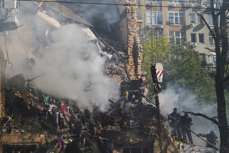 Rescuers work to clear the rubble of a residential building destroyed by a ''kamikaze drone'' attack in downtown Kyiv, Ukriane, on October 17, 2022 (Photo by Oleg Pereverzev/NurPhoto via Getty Images)