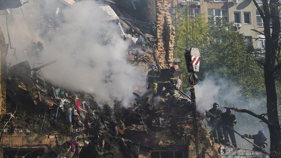 Rescuers work to clear the rubble of a residential building destroyed by a ''kamikaze drone'' attack in downtown Kyiv, Ukriane, on October 17, 2022 (Photo by Oleg Pereverzev/NurPhoto via Getty Images)