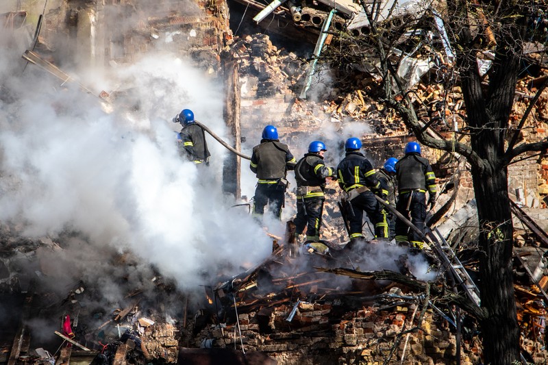 Rescuers work to clear the rubble of a residential building destroyed by a ''kamikaze drone'' attack in downtown Kyiv, Ukriane, on October 17, 2022 (Photo by Oleg Pereverzev/NurPhoto via Getty Images)
