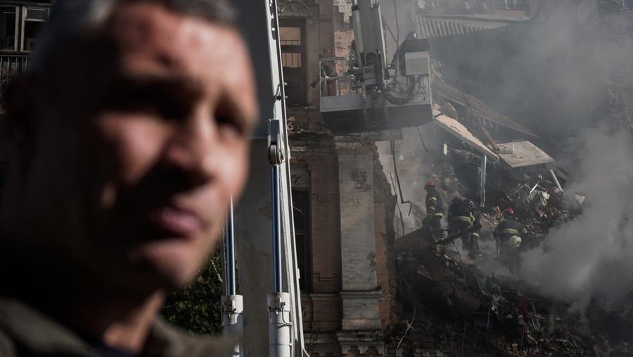 Rescuers work to clear the rubble of a residential building destroyed by a ''kamikaze drone'' attack in downtown Kyiv, Ukriane, on October 17, 2022 (Photo by Oleg Pereverzev/NurPhoto via Getty Images)
