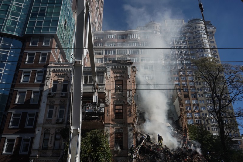 Rescuers work to clear the rubble of a residential building destroyed by a ''kamikaze drone'' attack in downtown Kyiv, Ukriane, on October 17, 2022 (Photo by Oleg Pereverzev/NurPhoto via Getty Images)