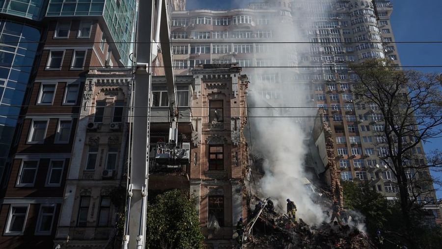 Rescuers work to clear the rubble of a residential building destroyed by a ''kamikaze drone'' attack in downtown Kyiv, Ukriane, on October 17, 2022 (Photo by Oleg Pereverzev/NurPhoto via Getty Images)