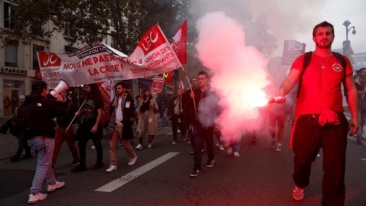 Protestors attend a demonstration in Paris as part of a nationwide day of strike and protests for higher wages and against requisitions at refineries in France, October 18, 2022. The slogan reads 