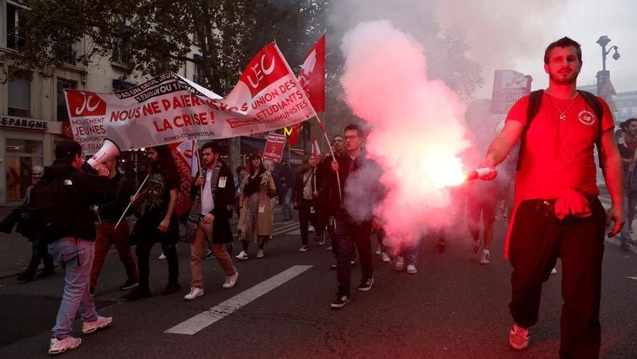 Protestors attend a demonstration in Paris as part of a nationwide day of strike and protests for higher wages and against requisitions at refineries in France, October 18, 2022. The slogan reads