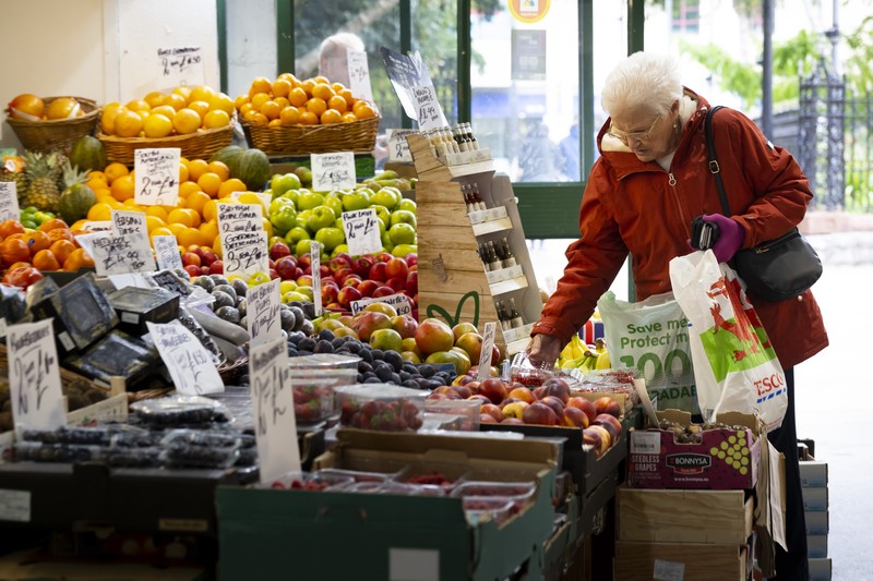 CARDIFF, WALES - OCTOBER 19: A woman shops in a greengrocers in Cardiff Market on October 19, 2022 in Cardiff, United Kingdom. The Office for National Statistics (ONS) said the consumer prices index (CPI) measure rose from an annual rate of 9.9% in August to match the recent 40-year high of 10.1% seen in July. The largest contributing factor being the rise in food costs. (Photo by Matthew Horwood/Getty Images)