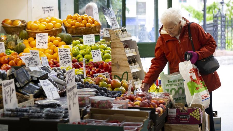 CARDIFF, WALES - OCTOBER 19: A woman shops in a greengrocers in Cardiff Market on October 19, 2022 in Cardiff, United Kingdom. The Office for National Statistics (ONS) said the consumer prices index (CPI) measure rose from an annual rate of 9.9% in August to match the recent 40-year high of 10.1% seen in July. The largest contributing factor being the rise in food costs. (Photo by Matthew Horwood/Getty Images)