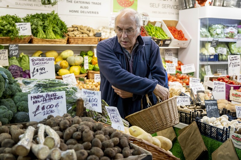 CARDIFF, WALES - OCTOBER 19: A woman shops in a greengrocers in Cardiff Market on October 19, 2022 in Cardiff, United Kingdom. The Office for National Statistics (ONS) said the consumer prices index (CPI) measure rose from an annual rate of 9.9% in August to match the recent 40-year high of 10.1% seen in July. The largest contributing factor being the rise in food costs. (Photo by Matthew Horwood/Getty Images)