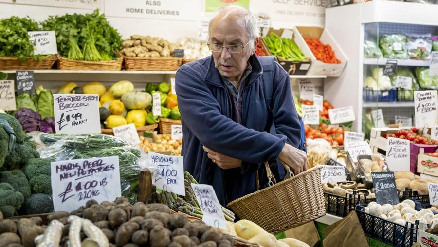 CARDIFF, WALES - OCTOBER 19: A woman shops in a greengrocers in Cardiff Market on October 19, 2022 in Cardiff, United Kingdom. The Office for National Statistics (ONS) said the consumer prices index (CPI) measure rose from an annual rate of 9.9% in August to match the recent 40-year high of 10.1% seen in July. The largest contributing factor being the rise in food costs. (Photo by Matthew Horwood/Getty Images)