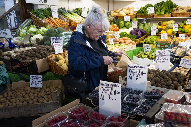 CARDIFF, WALES - OCTOBER 19: A woman shops in a greengrocers in Cardiff Market on October 19, 2022 in Cardiff, United Kingdom. The Office for National Statistics (ONS) said the consumer prices index (CPI) measure rose from an annual rate of 9.9% in August to match the recent 40-year high of 10.1% seen in July. The largest contributing factor being the rise in food costs. (Photo by Matthew Horwood/Getty Images)