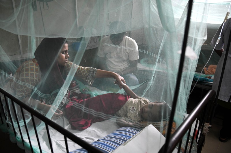 Children are kept inside mosquito nets as they are hospitalized due to dengue fever at Dhaka Child Hospital in Dhaka, Bangladesh on October 19, 2022.  Bangladesh logged its highest daily caseload of dengue fever on Tuesday, with 900 cases reported over the past 24 hours, raising the total tally to 26,938 in the country this year, according to the Media Report. (Photo by Syed Mahamudur Rahman/NurPhoto via Getty Images)
