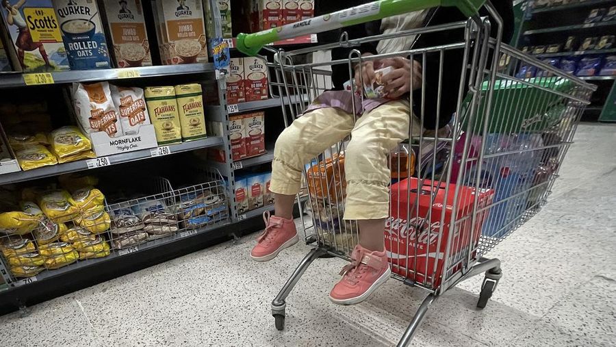 MANCHESTER, UNITED KINGDOM - OCTOBER 19: Shoppers buy groceries in an Asda supermarket on October 19, 2022 in Manchester, United Kingdom. The Office for National Statistics (ONS) said the consumer prices index (CPI) measure rose from an annual rate of 9.9% in August to match the recent 40-year high of 10.1% seen in July. The largest contributing factor being the rise in food costs. (Photo by Christopher Furlong/Getty Images)